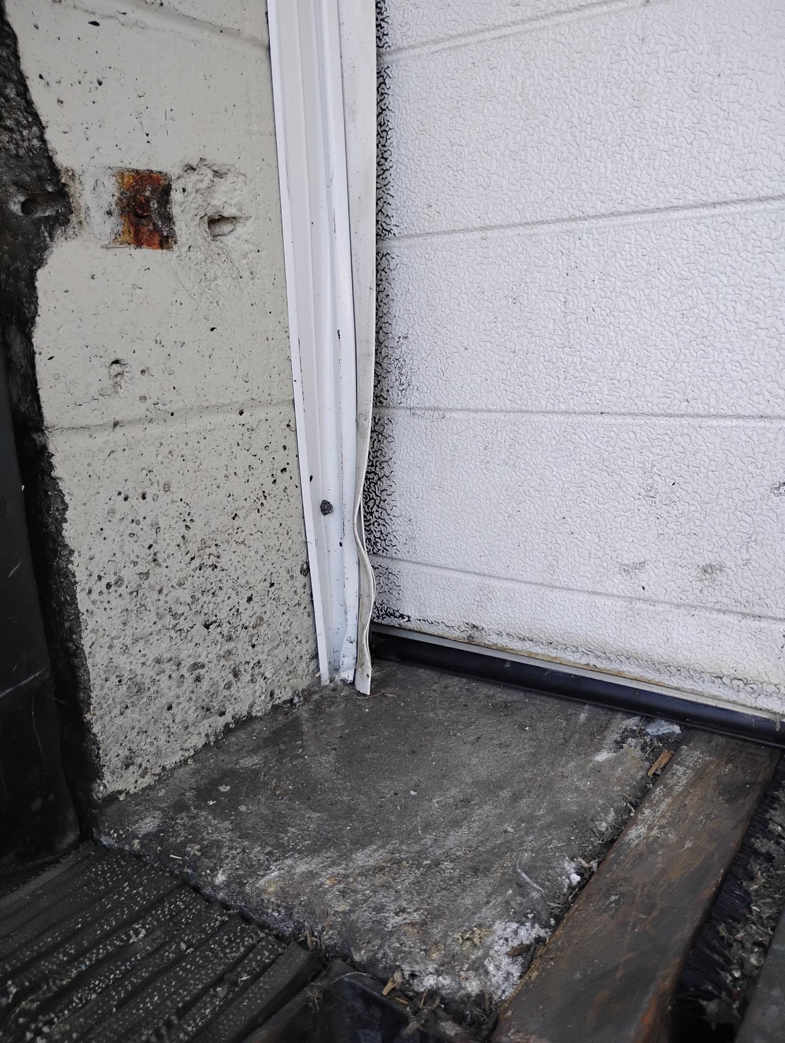 Damaged overhead door bottom section and track repair