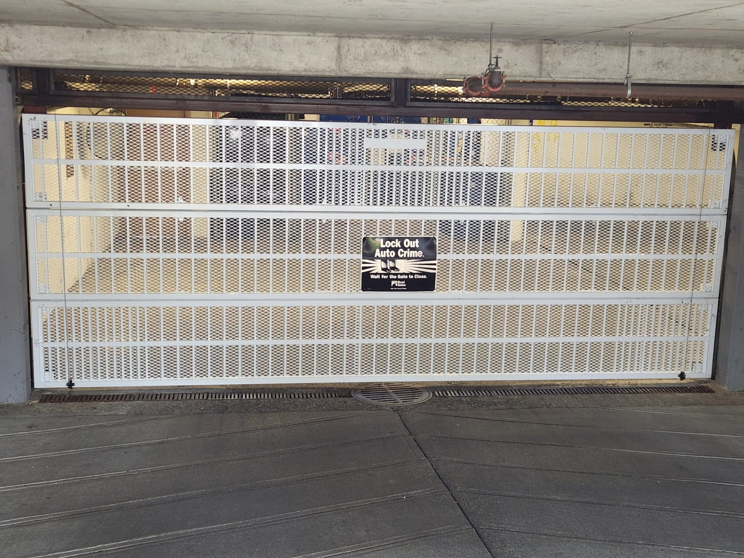 White mesh parking gate at strata parkade
