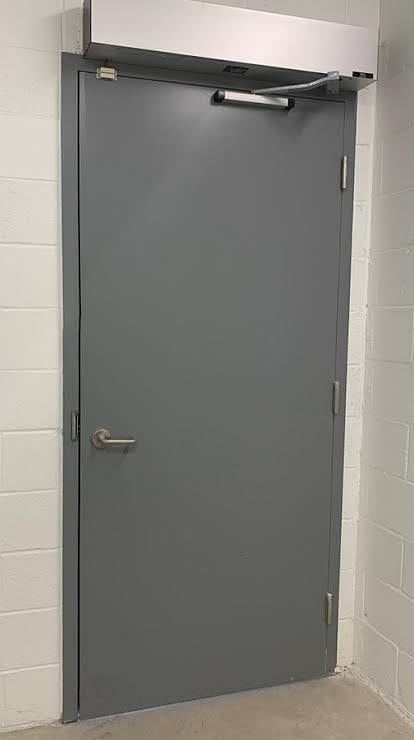 Steel man door with panic bar hardware and steel frame